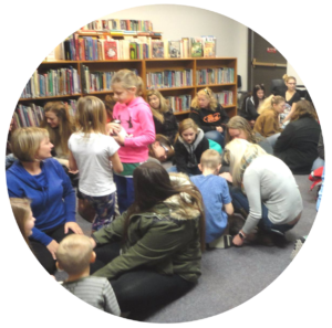 A group of people holding kittens at the Gretna Public Library's Kitty Café.