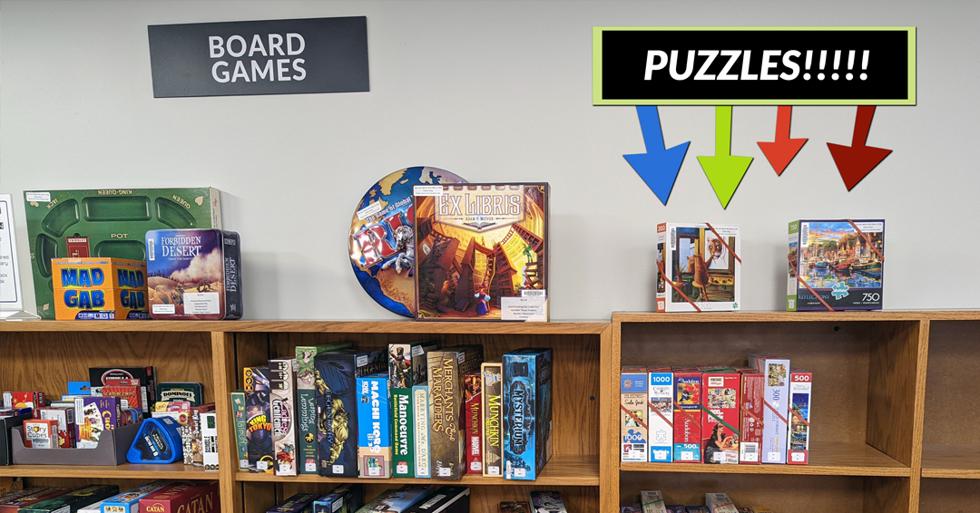 Several bookshelves full of board games and puzzles.