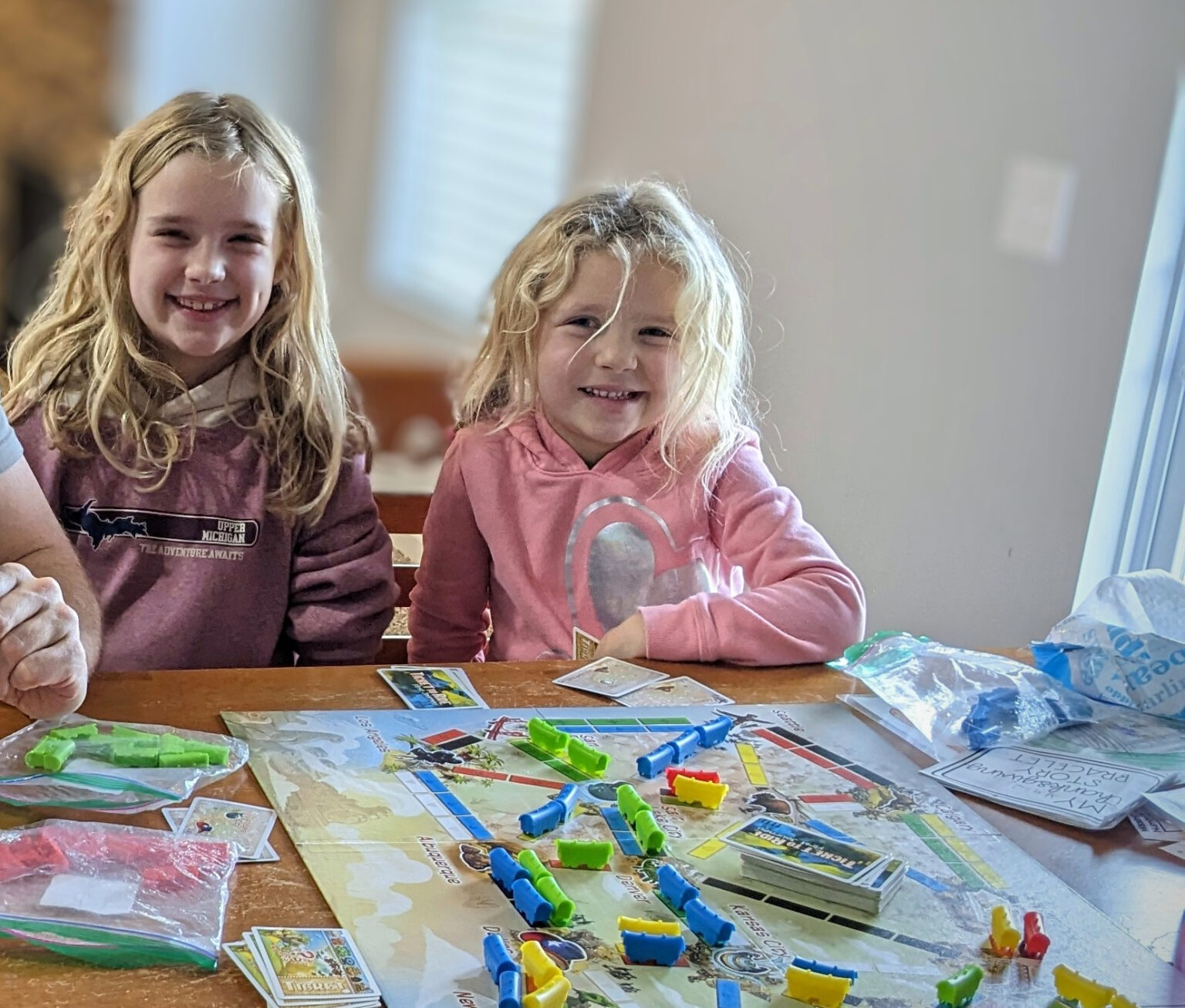 Two girls smile after a game of Ticket to Ride Jr.